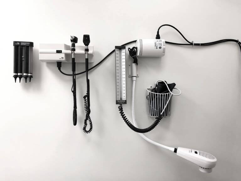 A white and black photo of a doctor's office with ENT equipment for a health and wellness article about clinical strength and doctor-developed products