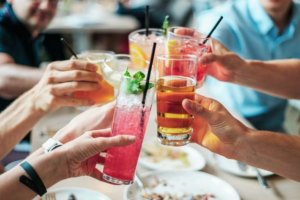 A group of people toasting with non-alcoholic beverages for an article about the sober curious trend