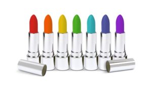 Rainbow colored lipsticks in silver applicators for a multi-sensory article about color changing cosmetics and flavor changing products
