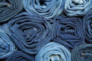 Rolled denim jeans as an example of scented clothes for a fragrance article about multi-sensory scented products