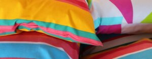 Four colorful soft striped pillows