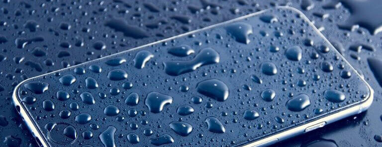 Wet purple smartphone covered in water droplets