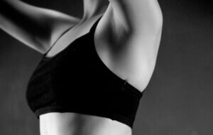 Close up woman raised arm in black exercise bra to depict deodorant innovation