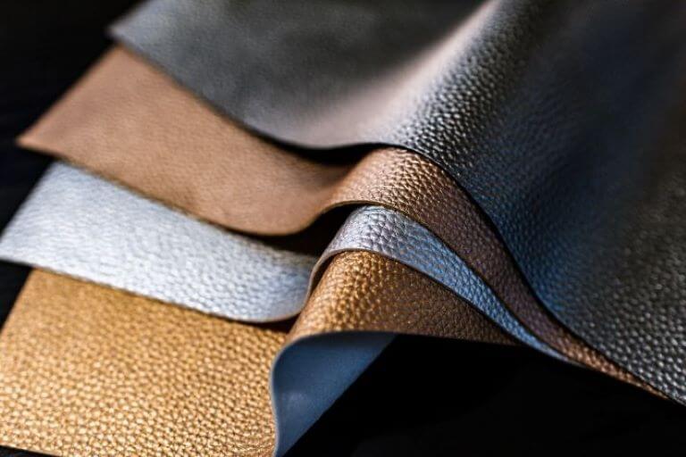 Brown and blue textured pieces of leather fabric for a trend article on vegan leather alternatives