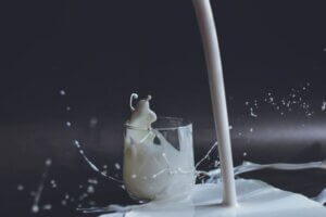 Milk poring into a glass splashing for milk trends article