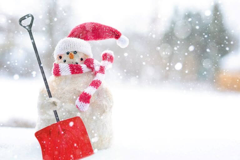 Snowman holding a red shovel in the the snow for a trend article about fragrance and flavor collaborations for the season